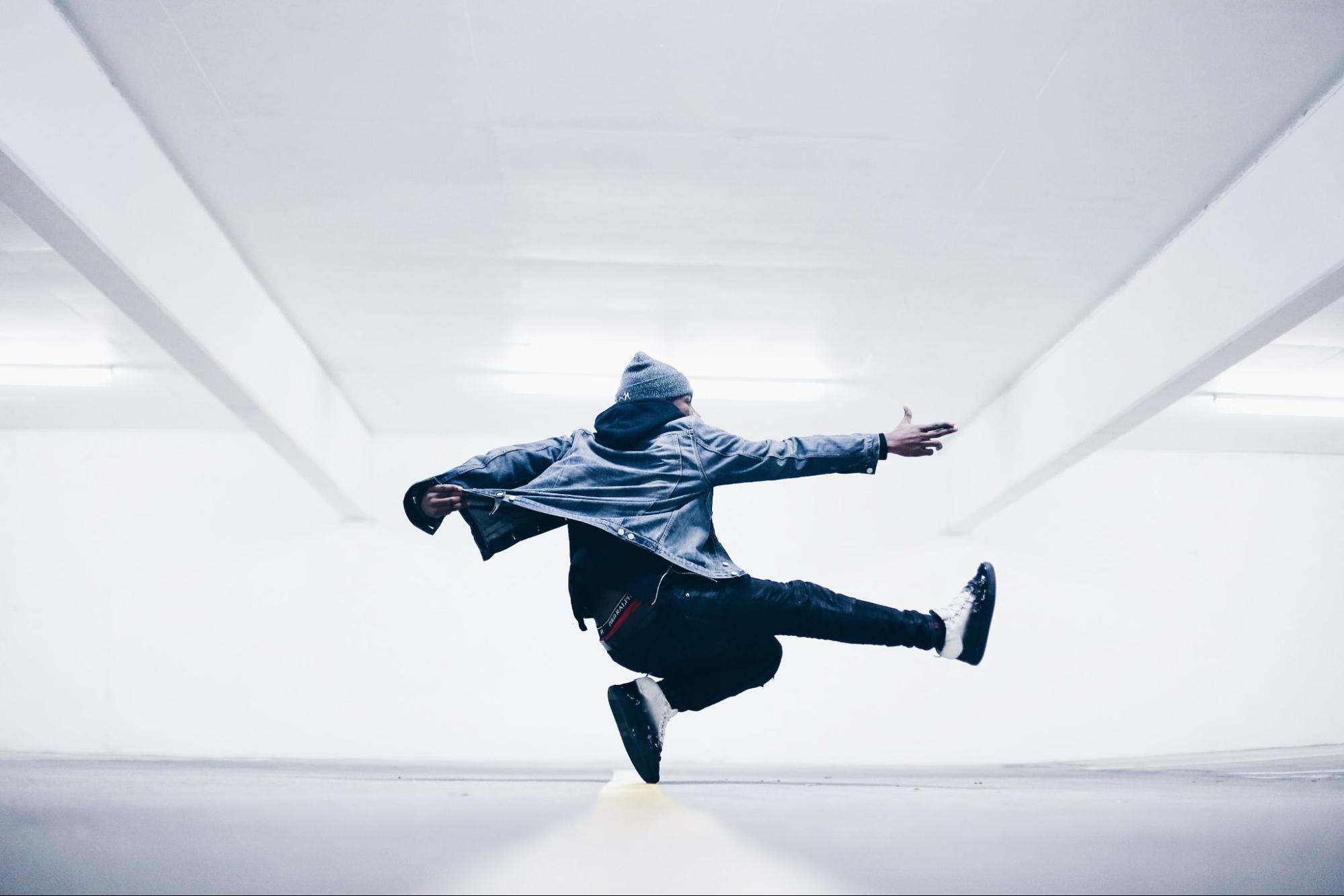 Person jumping in the air in all white room